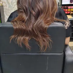The same beautiful mocha caramel shade, this time styled in soft waves. This shows how versatile the color is and how it catches the light differently with texture.