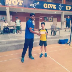 A young boy from my academy receiving his prize at a junior championship. I focus on building a strong foundation for future success.