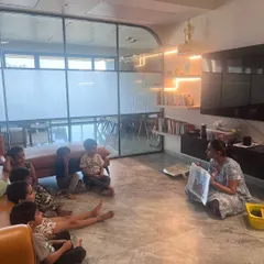 A group of little coders listening intently to the story that sets up their next challenge. We use narratives to make abstract concepts like sequencing and algorithms relatable and fun.