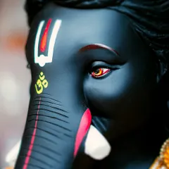 The details are where the devotion truly lies. This close-up of a magnificent black Ganpati idol focuses on the expressive eyes and the sacred 'Om' symbol. Capturing these intricate details is how I tell the story of the artistry and faith behind each idol.