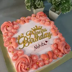 A lovely square cake with pink piping and a "Princess Birthday" topper.