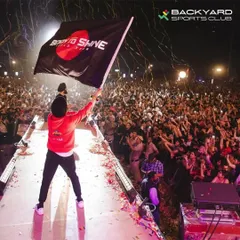 The energy is electric when a star like Diljit Dosanjh takes the stage, waving a 'Born to Shine' tour flag over a sea of thousands of cheering fans and phone lights.