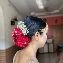 A side view of the rose bun, highlighting how it elegantly sits at the nape of the neck.