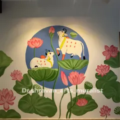 This wall mural captures the serene beauty of Pichwai art. The composition, featuring cows amidst lotus pads under a soft spotlight, creates a peaceful and divine atmosphere in the room.