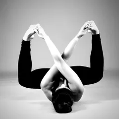 To lines and shapes. This variation of Anandabalasana, or Happy Baby Pose, creates a beautiful, symmetrical pattern. It's a restorative pose that also gently opens the hips.