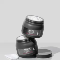 A sleek, monochromatic composition for a modern hair mask. The stacked jars create a sense of architectural balance, while the creamy swatch on the side gives a hint of the product's rich texture.