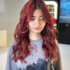 Another angle of this stunning red hair transformation. The color is rich and consistent, with beautiful, soft waves.