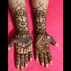 This design combines floral bouquets with hanging jhumkas and peacock motifs, blending modern and traditional elements beautifully.