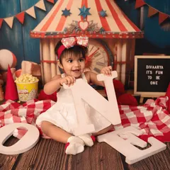 It's fun to be one under the big top! This vibrant carnival theme, with its classic red and white stripes, popcorn, and fun props, makes for an exciting first birthday shoot.