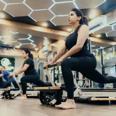 A group of clients performing a synchronized lunge on the reformer. This exercise is excellent for building lower body strength, improving balance, and engaging the core, all key components of my group classes at the Hauz Khas studio.