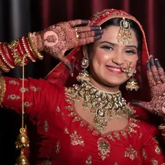 A radiant bride shows off her intricate henna design, a beautiful detail shot that's part of our comprehensive bridal portrait session.