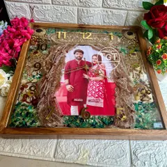 For a truly comprehensive wedding keepsake, we created this large 18-inch teakwood clock. It preserves not just the varmala, but also the groom’s sehra and the bride’s kalire, all arranged around a central wedding photo. It’s a complete story of the wedding rituals in one frame.