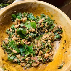 A fresh batch of my homemade Axone chutney. I make this by pounding fermented soya beans with roasted green chillies, tomato, ginger, and garlic, then finish it with fresh green leaves from my garden. The flavour is strong, pungent, and very traditional.