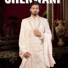 This is our classic ivory white sherwani, a timeless choice for any groom. We focus on intricate embroidery and a majestic fit, ensuring you look nothing less than royalty on your wedding day. We can customize the fabric and detailing just for you.