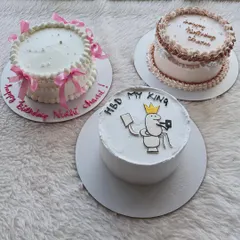 This was for a party with three different celebrations. I made three unique cakes: a fun cartoon cake, an elegant ribbon cake, and a classic piped border cake.