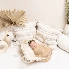 Wrapped in the softest hues of love and tranquility. This boho-inspired newborn setup uses natural textures and a neutral palette to create a calm and peaceful portrait.