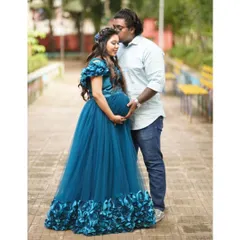 Planning a couple's maternity shoot is a wonderful way to capture this time together. Here, my client wears the teal floral gown while her partner stays comfortable and casual. I can help you style a coordinated look that feels authentic to you both.