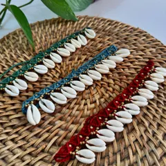 These macrame anklets with cowrie shells and gold beads are perfect for a beach vacation. They come in several rich colors like green, blue, and red.