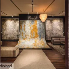 At the Hands Carpets exhibition, we designed the space to let the product be the hero. A dramatic, oversized carpet cascades from the wall to the floor, creating a powerful focal point that immediately communicates the brand's artistry and quality.