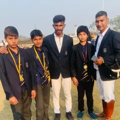 Instructors with young medal-winning students. We celebrate every achievement and are dedicated to helping our riders reach their full potential.