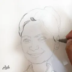 The process begins with a light pencil sketch to get the proportions and likeness just right.