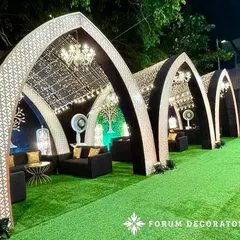 I designed these arched cabanas for a bohemian-themed Sangeet. The intricate laser-cut panels, string lights, and comfortable lounge seating create stylish and semi-private spaces for guests to relax.