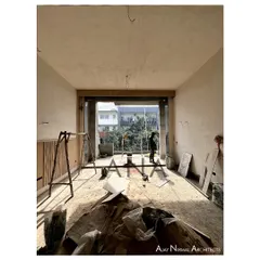The interior of the DLF Phase 1 residence during construction. Even in its unfinished state, the large window opening frames the view and demonstrates the design's focus on light.