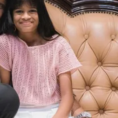 A sweet client wearing her light pink crochet top. The open stitchwork makes it lightweight and perfect for warmer weather, and the simple design is comfortable for play.