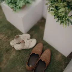 The bride's and groom's shoes, resting side-by-side. A simple, symbolic shot of two paths about to merge into one.