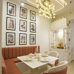 This view shows the dining area next to a beautiful, custom-designed pooja mandir, seamlessly integrating spiritual and family spaces.