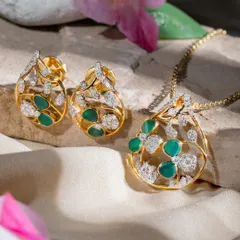 The Aranya pendant and earring set in its purest form, showcasing clean silhouettes and soft pearl accents against a natural backdrop.