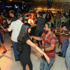 The whole studio comes alive during our Open Floor nights. Here you can see multiple couples dancing, practicing, and having fun in a relaxed, social setting.