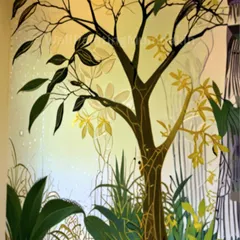 An elegant, stylized tree mural can add a touch of sophistication to any room. This design uses a mix of green and golden tones to create a warm and artistic focal point in this living space.