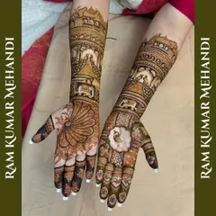 A stunning bridal design with a peacock feather on one palm and a floral motif on the other. The arms are adorned with palace scenes and peacocks.