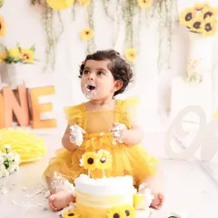 Nothing says "happy first birthday" like a cake smash! This little girl is having the best time with her sunflower themed cake, a perfect example of the pure, unscripted joy I love to capture.