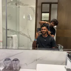 Final checks on the haircut. I make sure every detail is perfect before the client leaves the chair, ensuring a flawless look.
