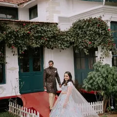 The couple shares a quiet moment outside the charming colonial-style venue in Ooty, showcasing the beautiful backdrop for their destination wedding.