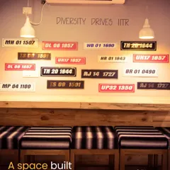 To build character and a sense of place, I incorporated this 'Diversity Drives IITR' wall. The collection of license plates from different states adds a quirky, local touch and serves as a great conversation starter for patrons.
