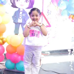 The birthday girl enjoying her 'Squid Game' themed party. I can provide themed cutouts and props that are kid-friendly and perfect for photos.