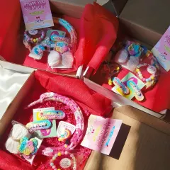 Getting multiple gift hampers ready to ship! Each box is filled with red tissue paper and a curated selection of our handmade accessories.