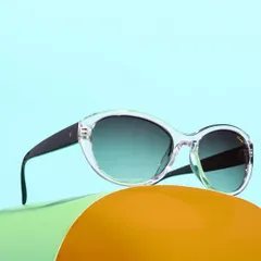 A vibrant shot of clear-framed sunglasses against a colorful, layered background. The use of bright colors and curved shapes makes the product feel modern and fun.