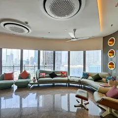 Another angle of the Jesrani Residence living room, highlighting the custom wall niches and the gentle curve of the space. The design ensures that every part of the room benefits from the incredible view and abundant daylight.