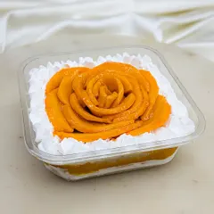 Our Mango Fresh Cream cake is also available in a tub. It's layered with our signature vanilla sponge, light cream, homemade aamras, and diced mangoes for a perfect summer treat.