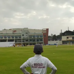 A young player from our academy, representing Lions Cricket Club, watches the action unfold during a KSCA Under-12 league match.