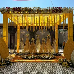 For a vibrant Haldi ceremony, we designed this stunning mandap drenched in shades of yellow. The setup includes a canopy with hanging floral strings, traditional marigold decorations, and a beautiful stage, making it the perfect backdrop for this joyous pre-wedding ritual.