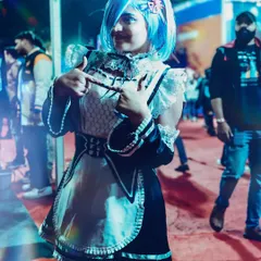 A full-body shot of the REM cosplay, showcasing the detailed maid outfit against the event backdrop. This provides a complete view of the costume, perfect for documenting the full effort of the cosplayer.