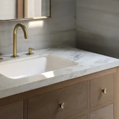 Even the smallest elements are an opportunity for thoughtful design. These custom brass knobs, seen here on a bathroom vanity, carry the material language of brass and wood into every corner of the DUA Villa.