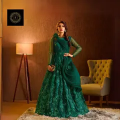 This emerald green gown is pure drama and elegance. The structured floral detail on the shoulder and the shimmering fabric create a truly unforgettable look.