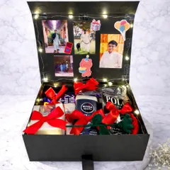 This birthday box for him is all about personalization. The lid opens to display a collection of his favorite photos, lit up with fairy lights, while the box itself is filled with grooming products and chocolates.