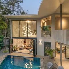 A stunning shot of the Moon House at dusk, as featured in Elle Decor India. The article praised the home's curved forms and raw textures, which are reminiscent of lunar landscapes, and its seamless connection to the outdoors.